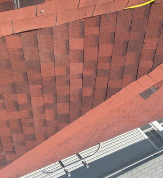 A roof with shingles and a ladder on top, showcasing roofing services by Greater Mansion, a general contractor.