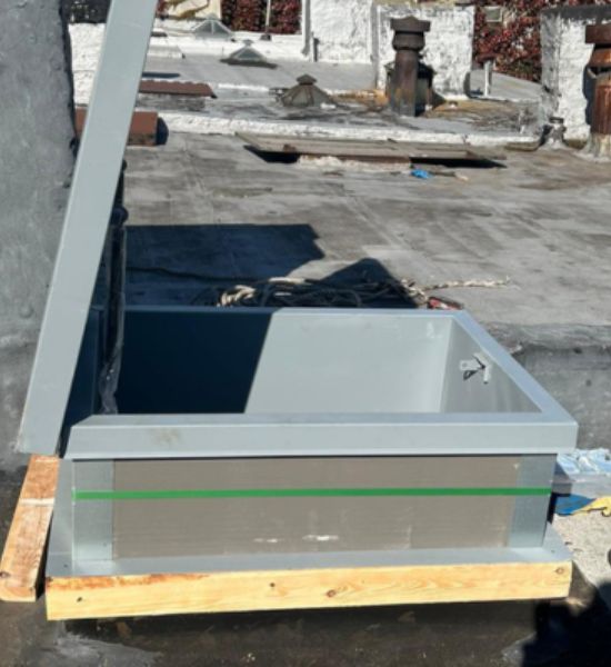 A metal box positioned on a rooftop, symbolizing construction and roofing services by Greater Mansion.