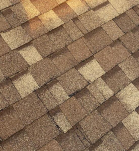 A brown shingle roof showcasing quality craftsmanship by Greater Mansion, a leader in construction and roofing services.