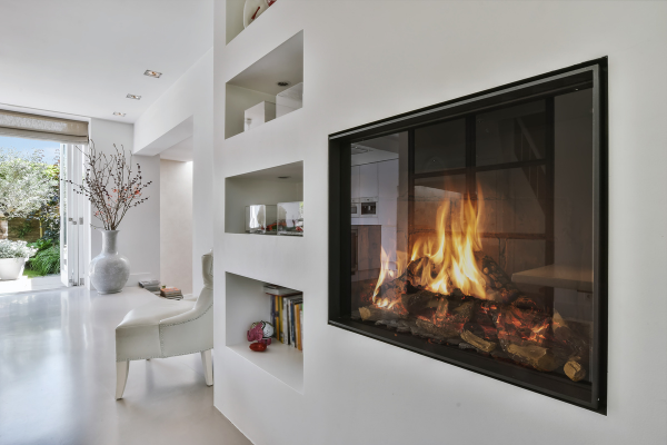 A modern fireplace in a stylish home featuring white walls, showcasing contemporary design elements and cozy ambiance.