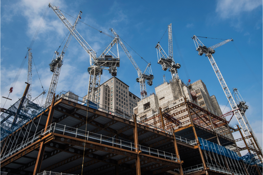 Construction cranes towering over a site, symbolizing Greater Mansion's expertise in building and remodeling services.