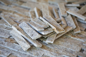 A collection of wooden pieces is displayed on a wooden floor, highlighting resources for building design and general contracting.