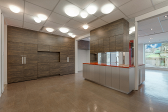 A modern kitchen featuring wooden cabinets and a spacious island, showcasing elegant design and functionality.