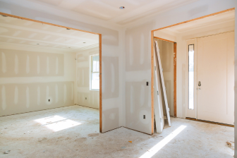 Interior view of a room under construction in Brooklyn, NY, featuring walls and drywall installation by Greater Mansion.