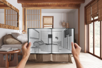 A person stands in a bedroom, holding a sketchbook, showcasing design ideas for construction and remodeling projects.