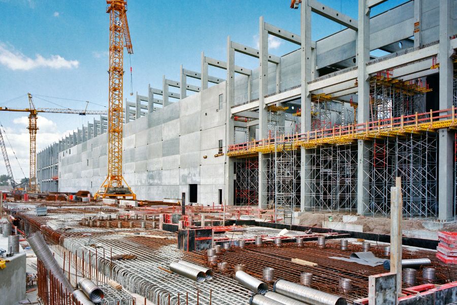 A large building under construction, featuring construction equipment, representing Greater Mansion's expertise in building design.